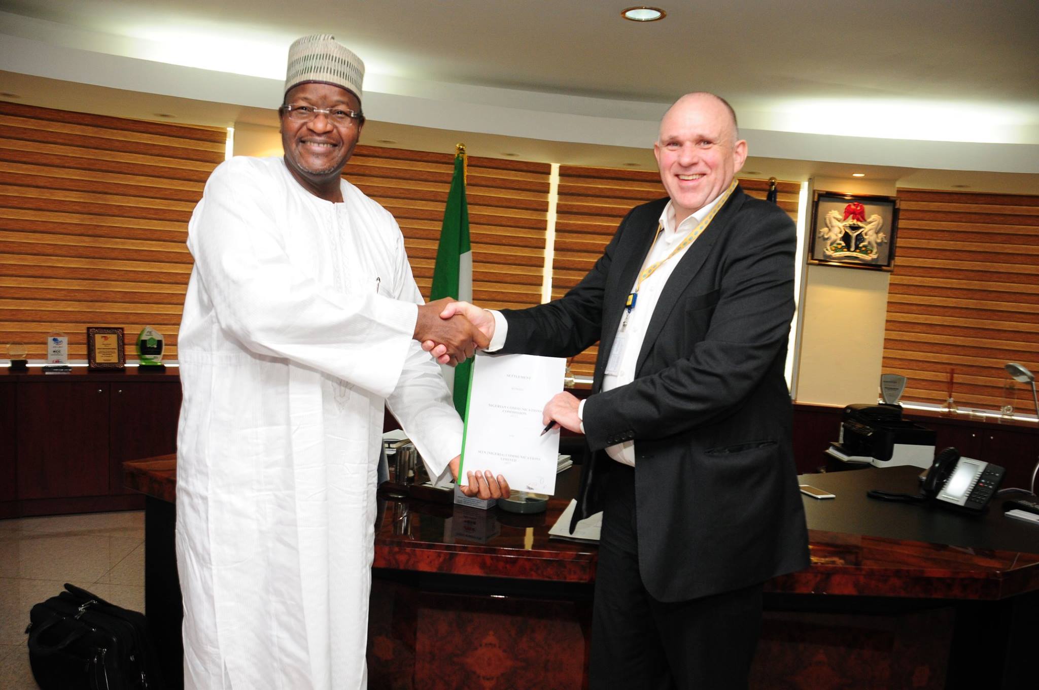 Executive Vice Chairman (EVC) of NCC, Professor Umar G. Danbatta, NCC (left) and Chief Executive Officer (CEO) of MTN, Fredinand (Fredi) Moolman, after the deal was signed