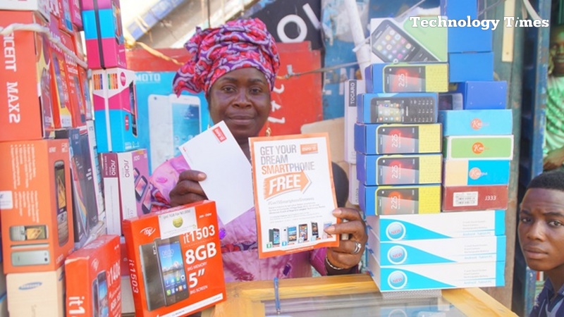 A mobile phone seller displays various models of mobile phones as Nigeria's mobile broadband market is projected to grow