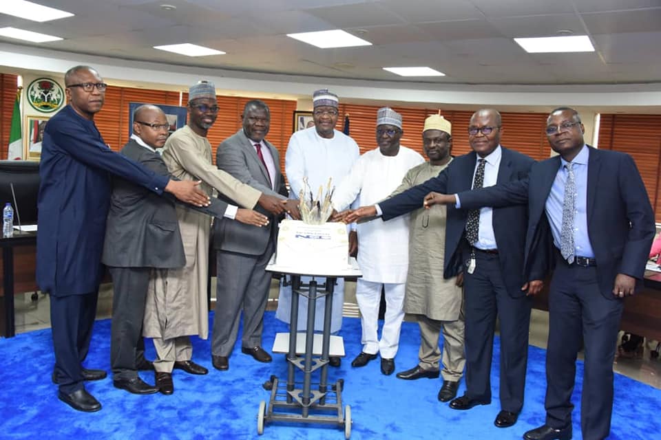 Professor Umar Garba Danbatta, Executive Vice Chairman and Chief Executive, NCC, middle, and some of the retiring officials cut the cake at the valedictory ceremony held at the NCC headquarters in Abuja.